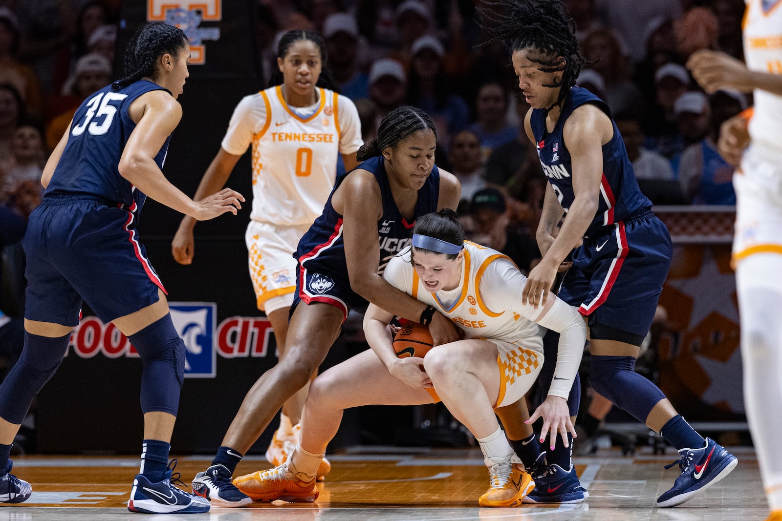 Tennessee guard Tess Darby (21) battles for the ball with UConn forward Sarah Strong, left, and guard KK Arnold (2) during the first half of an NCAA college basketball game Thursday, Feb. 6, 2025, in Knoxville, Tenn. (AP Photo/Wade Payne)