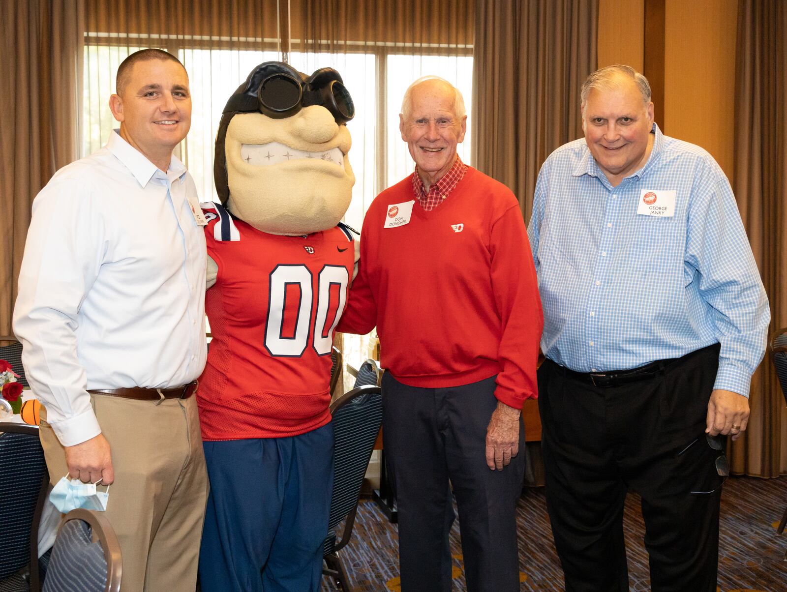 Don Donoher, second from right, poses with Dayton Athletic Director Neil Sullivan, left, Rudy Flyer and George Janky, right, during a reunion of Donoher's former players on Oct. 9, 2021, in Dayton. Photo courtesy of Natalie Schindler Photography