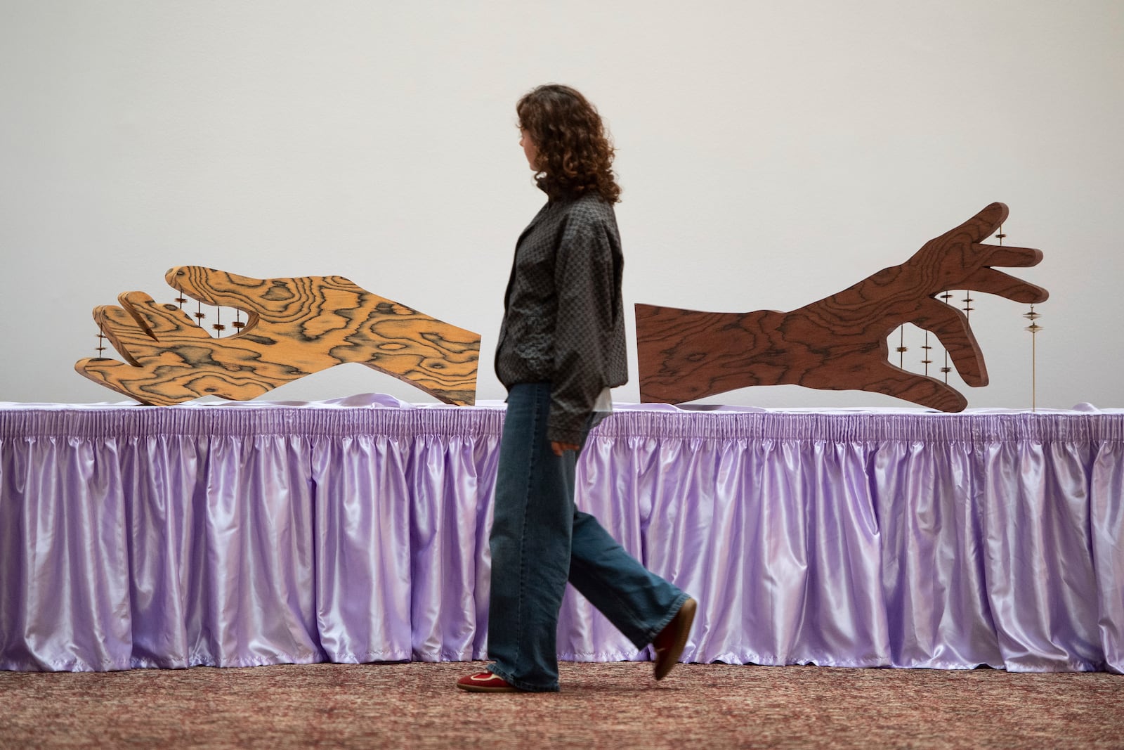 FILE - A woman walks past an artwork by Jasleen Kaur during the Turner Prize 2024 press preview at Tate Britain in London, Sept. 24, 2024. (AP Photo/Thomas Krych)