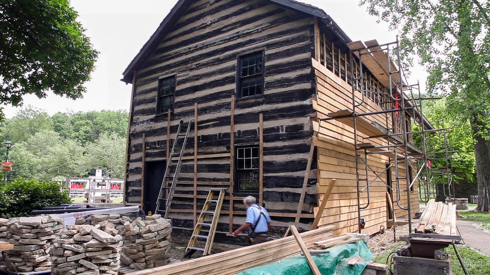 White oak and wrought nails are being used for the restoration of siding on Newcom Tavern.  The building was originally covered with wood siding which was removed to display the log construction of the building..  TY GREENLEES / STAFF.