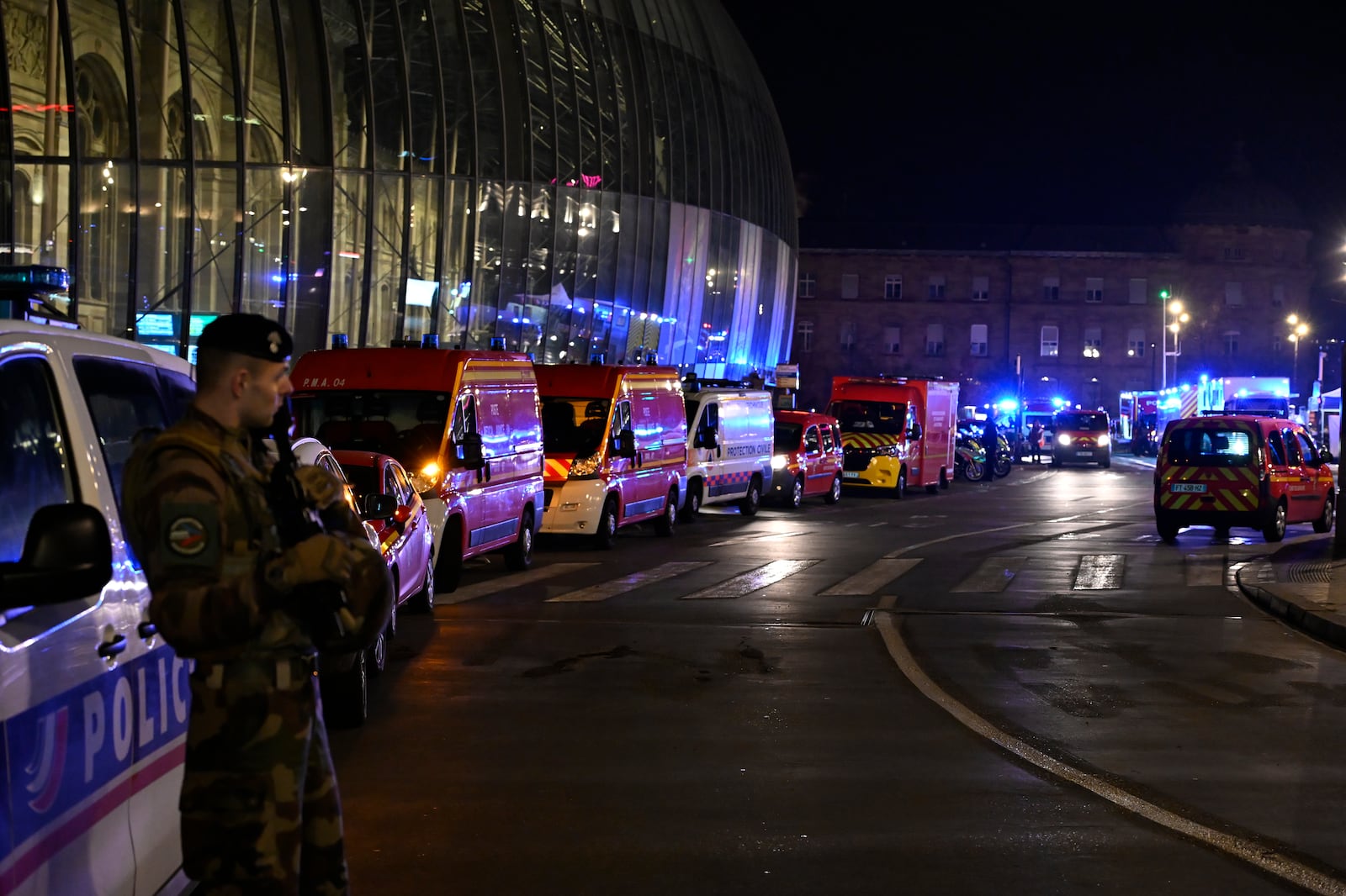 A soldier guards the train station after two trams collided, injuring dozens of people, though none critically, firefighters said, Saturday, Jan. 11, 2025 in Strasbourg, eastern France. (AP Photo/Pascal Bastien)