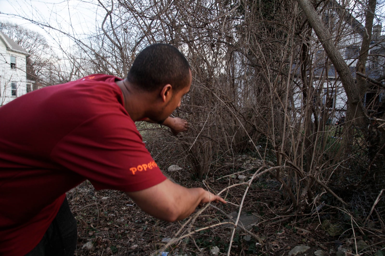 Jordan Gonzalez shows where the body of Kathleen Driscoll, 31, of Dayton was found in the vacant lot next to his 35 Ernst Avenue home in Dayton on January 12. STAFF Byron Stirsman