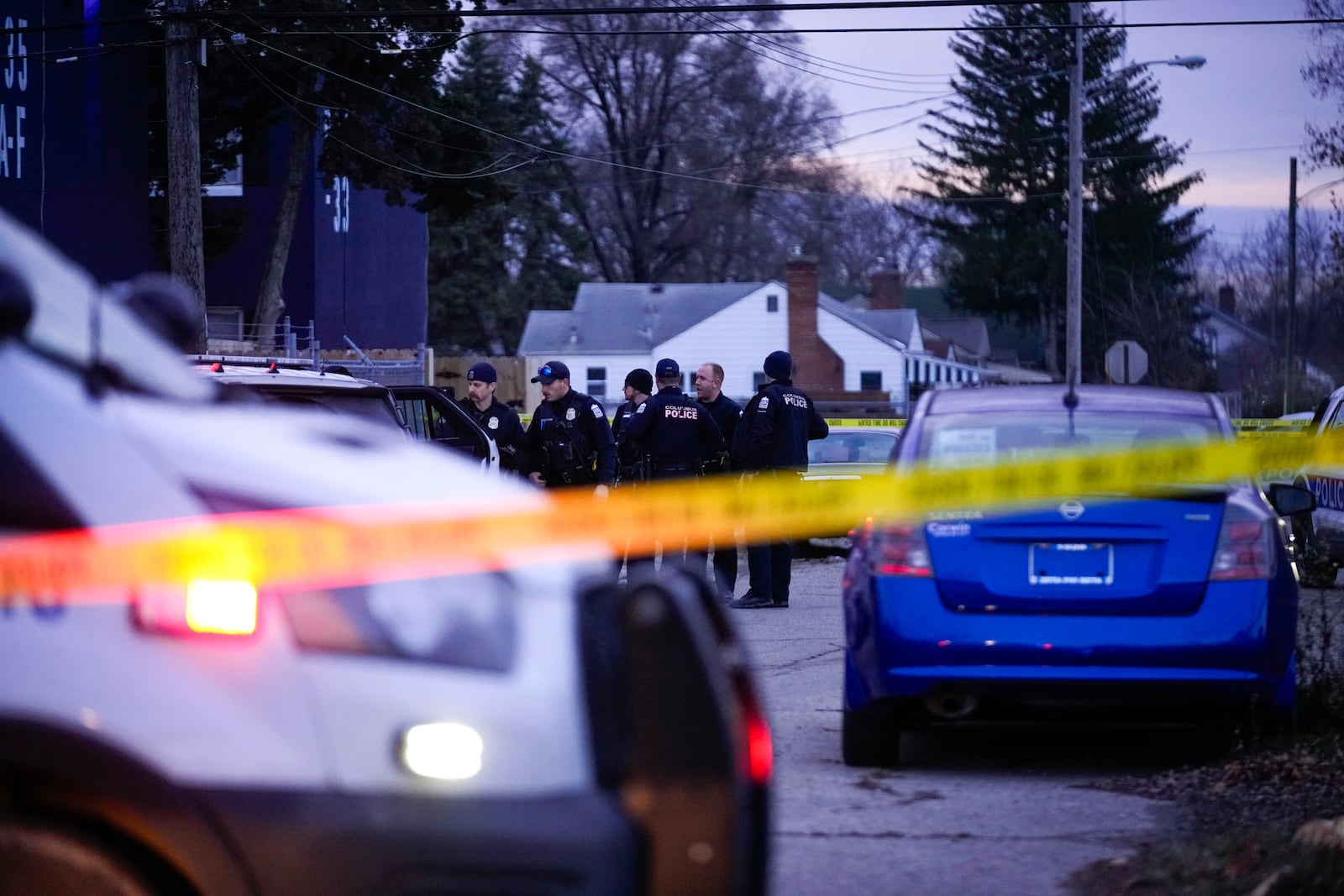 Columbus Police Department investigate the scene of a homicide on South Ohio Avenue as seen from the intersection of East Mithoff Street and South Ohio Avenue on Saturday, Dec. 14, 2024, in Columbus, Ohio. (Samantha Madar/The Columbus Dispatch via AP)