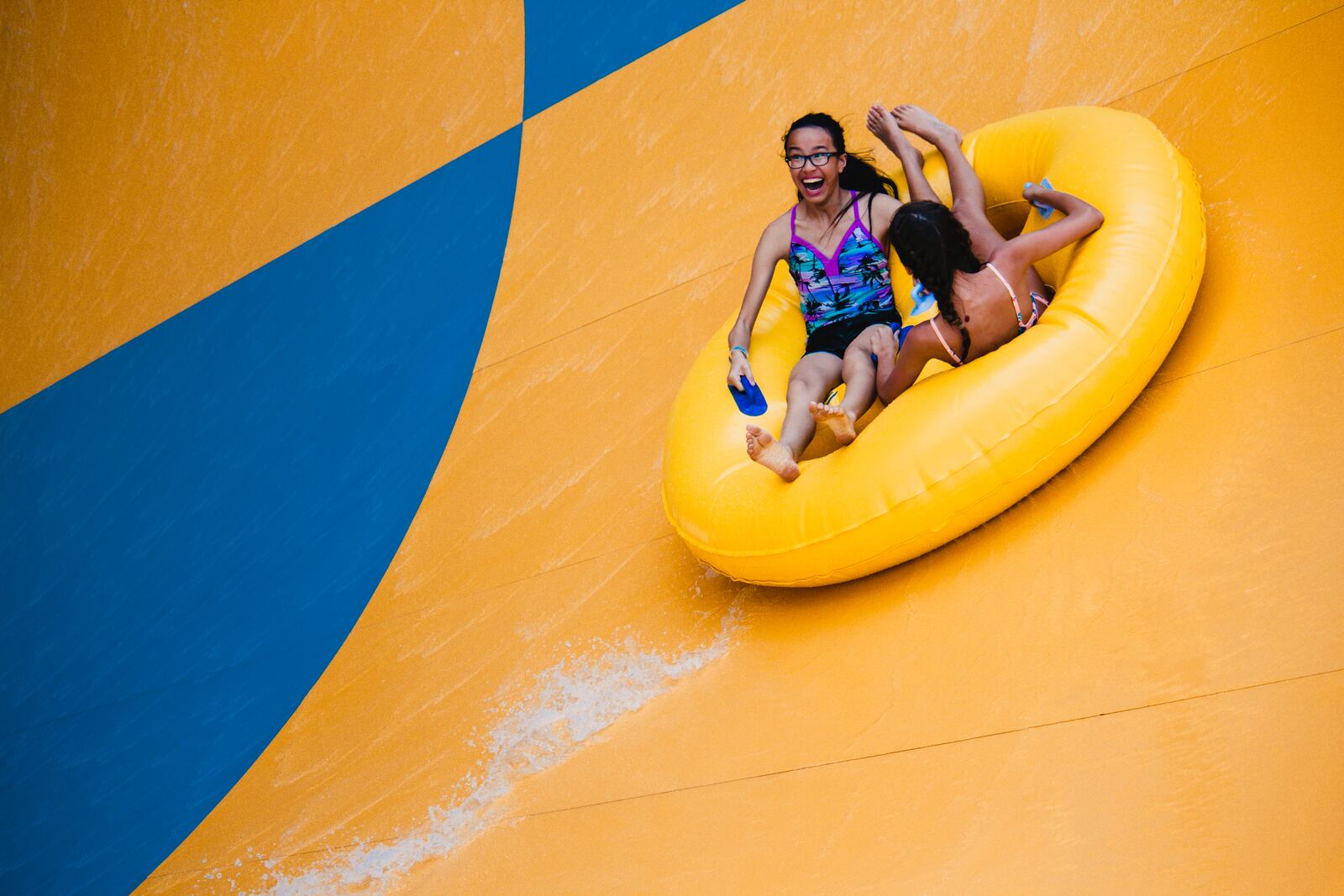 Participants ride the Tornado water slide at Kentucky Kingdom.