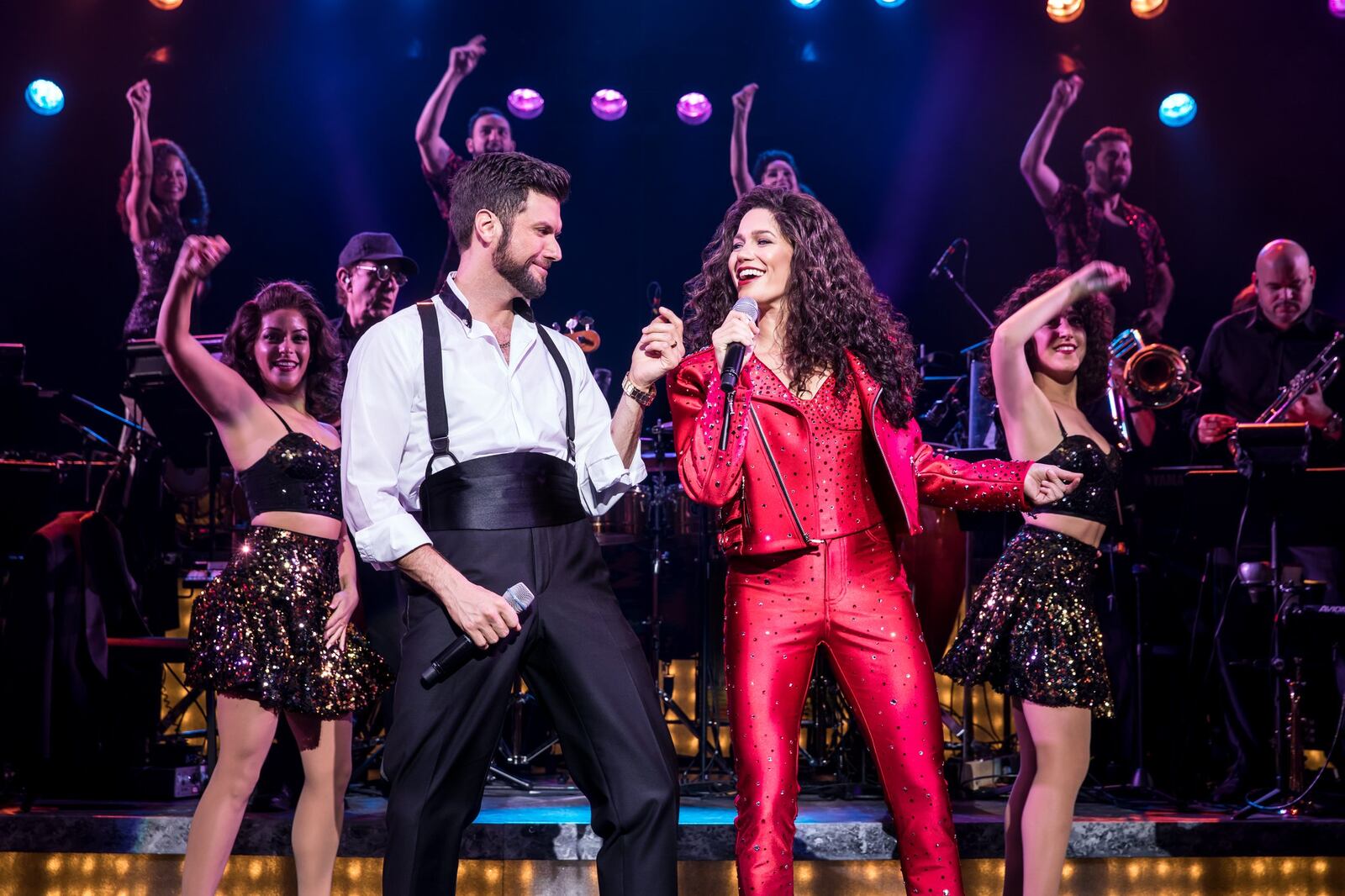 Mauricio Martinez as Emilio Estefan and Christie Prades as Gloria Estefan with the Company in the national tour of “On Your Feet!,” slated March 5-10 at the Schuster Center. CONTRIBUTED/MATTHEW MURPHY