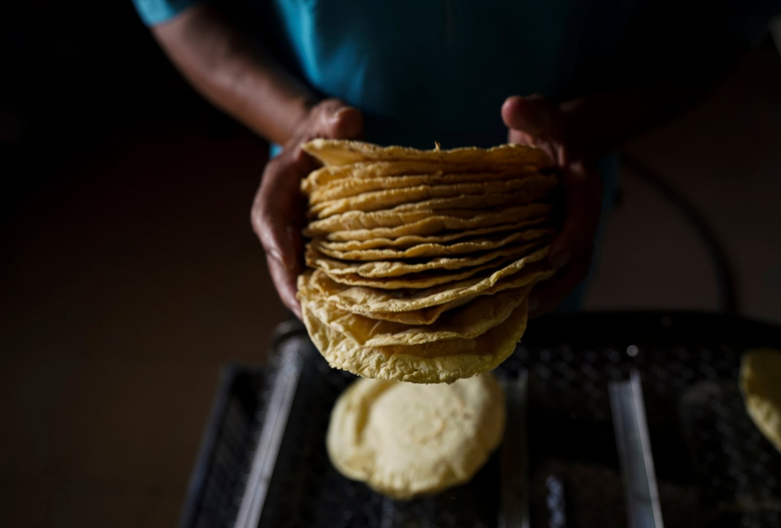 FILE - A worker packages tortillas to sell at a tortilla factory in Mexico City, May 9, 2022. (AP Photo/Fernando Llano, File)