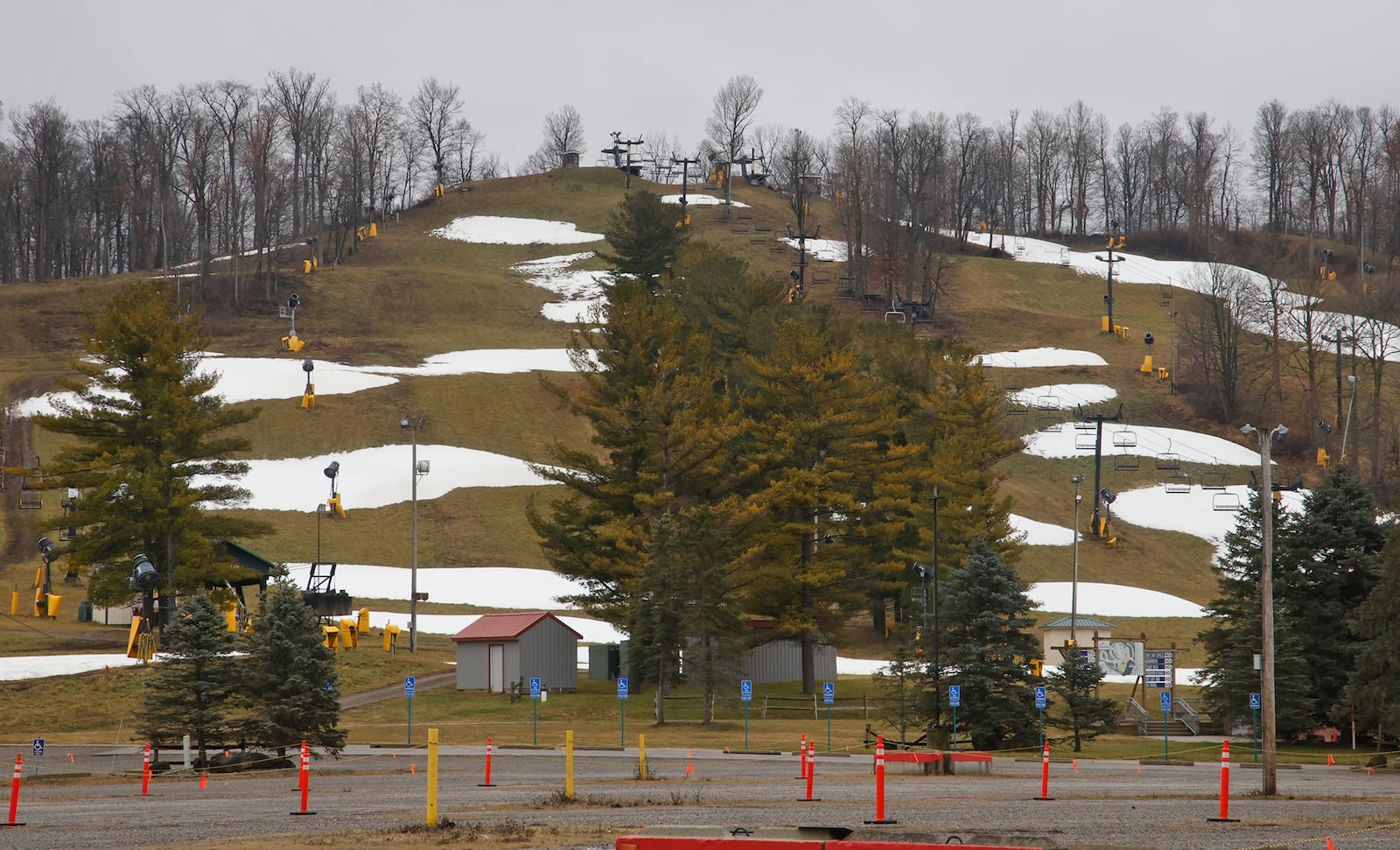 The snow at Mad River Mountain in Logan County had turned to puddles as temperatures reached the mid 50's Tuesday, Dec. 26, 2023. BILL LACKEY/STAFF