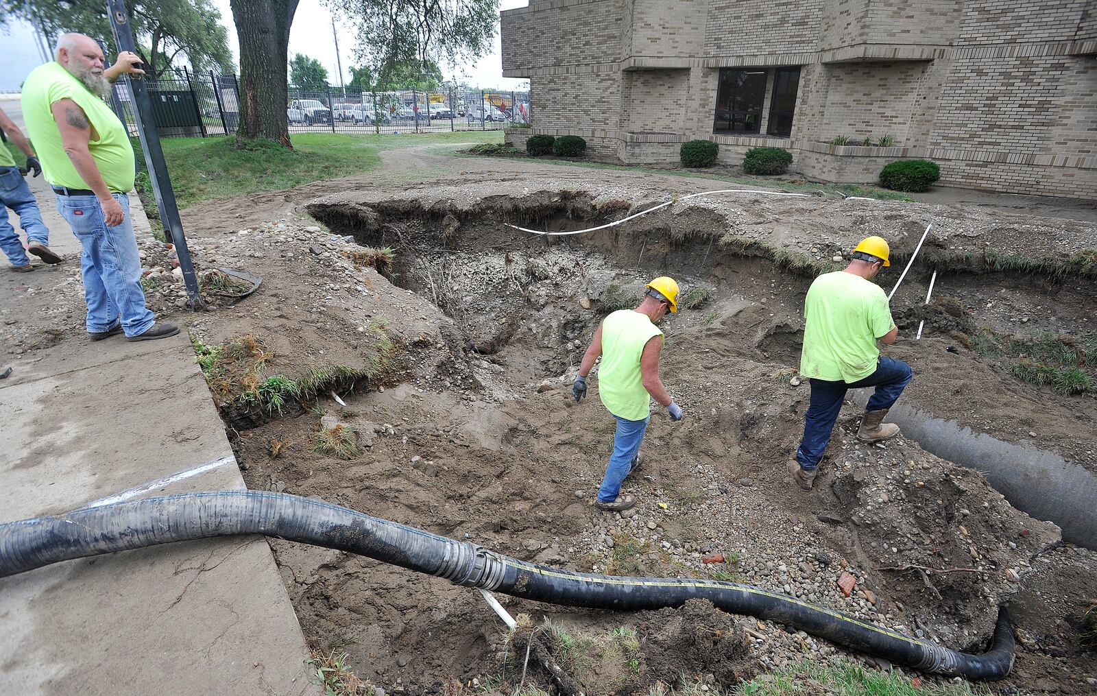 Dayton Street crews work to repair a large watermain break along Keowee Street in August. MARSHALL GORBY\STAFF