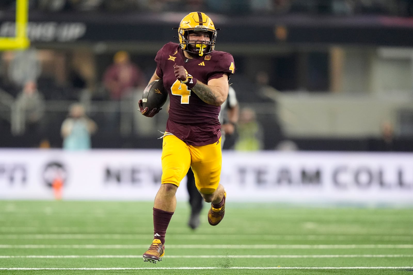 Arizona State running back Cam Skattebo (4) carries the ball for a long gain against Iowa State in the first half of the Big 12 Conference championship NCAA college football game, in Arlington, Texas, Saturday Dec. 7, 2024. (AP Photo/LM Otero)