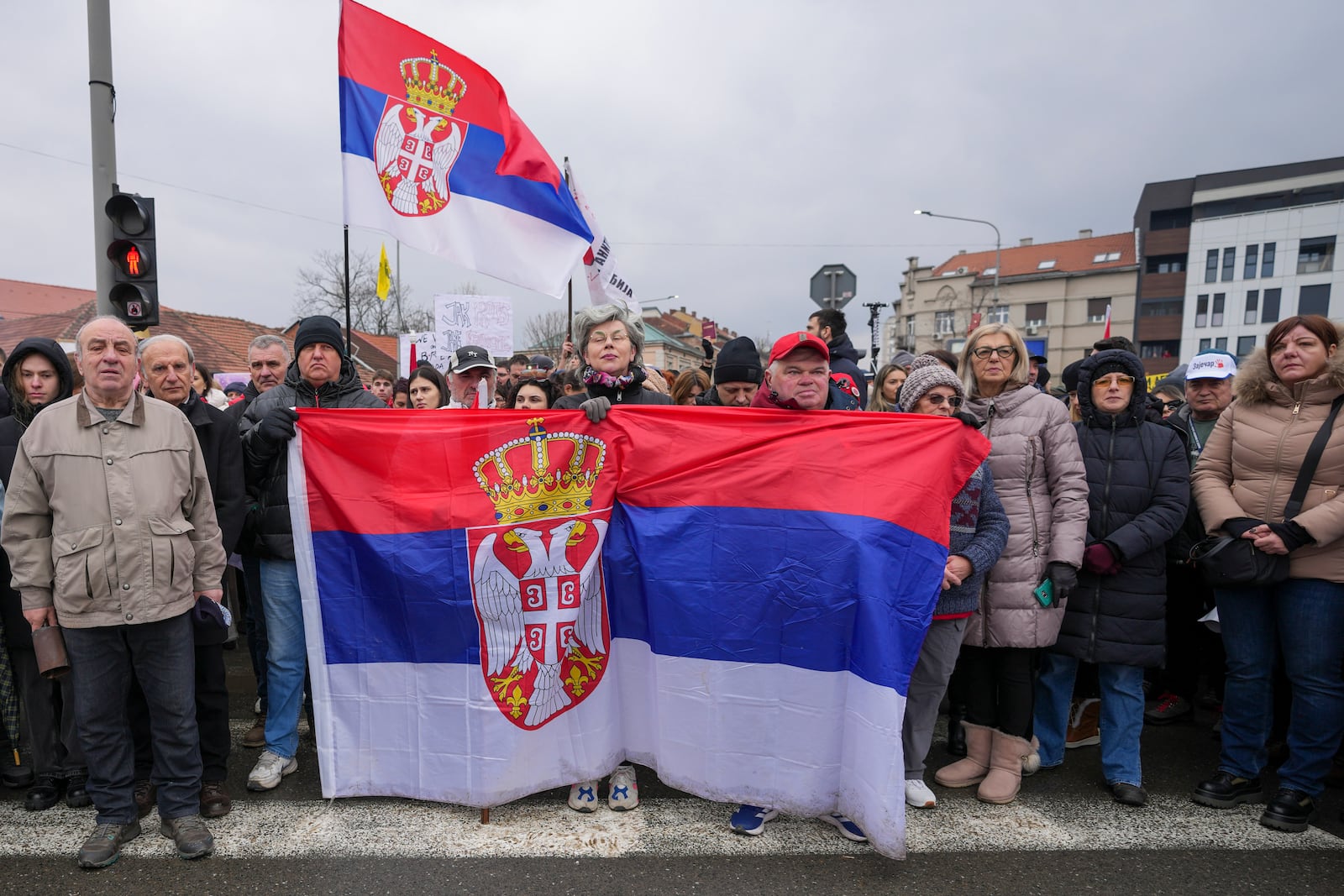 People attend a minute of silence during a protest triggered after a concrete canopy on a railway station in the northern city of Novi Sad collapsed on Nov. 1, 2024 killed 15 people, in Kragujevac, Serbia, Saturday, Feb. 15, 2025. (AP Photo/Darko Vojinovic)