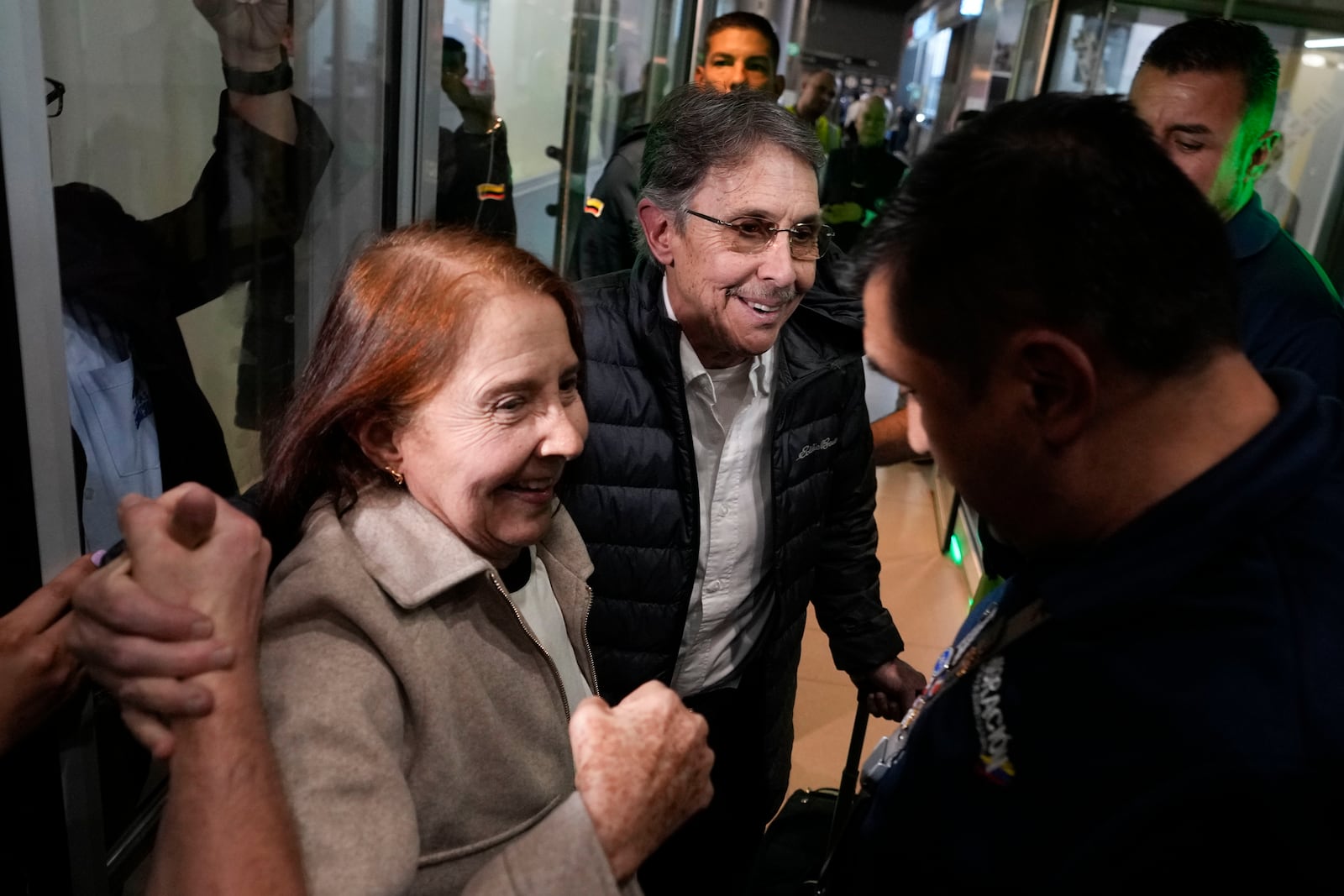 Fabio Ochoa, center, a former member of Cartel of Medellin, is welcomed by relatives upon arriving at El Dorado airport after being deported from the United States, in Bogota, Colombia, Monday, Dec. 23, 2024. (AP Photo/Fernando Vergara)