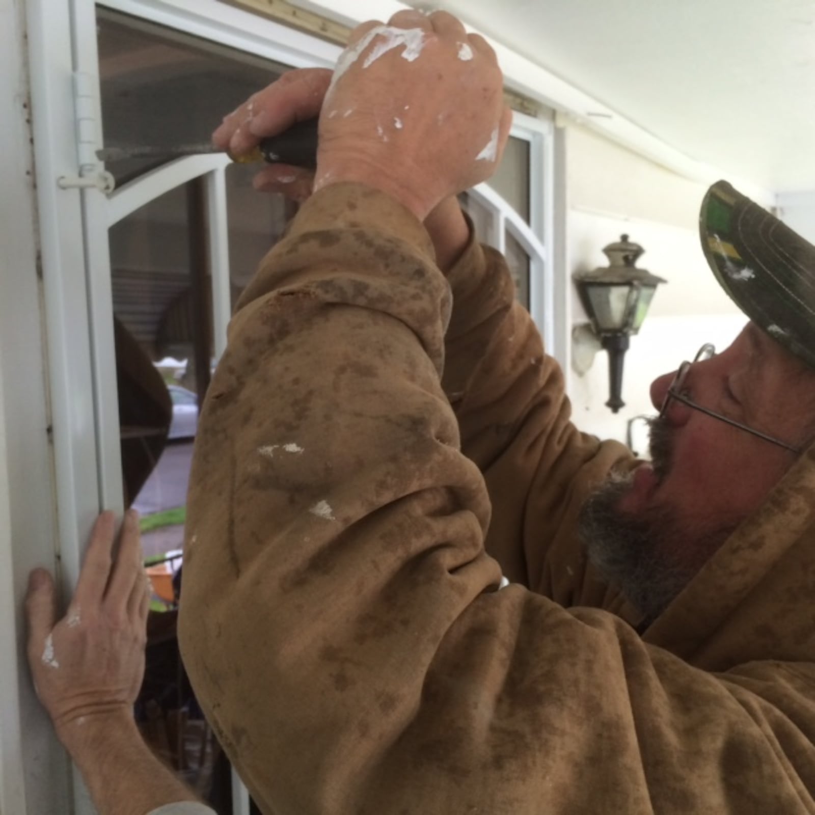 A volunteer with Rebuilding Together Dayton works on repairs to a home on Lorenz Avenue, Dayton April 25, 2015. (Randy Ragsdale/Staff)