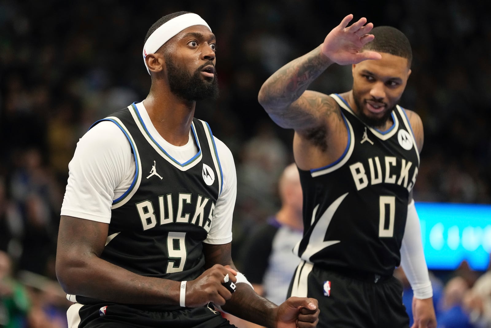 Milwaukee Bucks' Damian Lillard congratulates Bobby Portis after a last second three pointer during the first half of an Emirates NBA cup tournament basketball game Friday, Nov. 22, 2024, in Milwaukee. (AP Photo/Morry Gash)