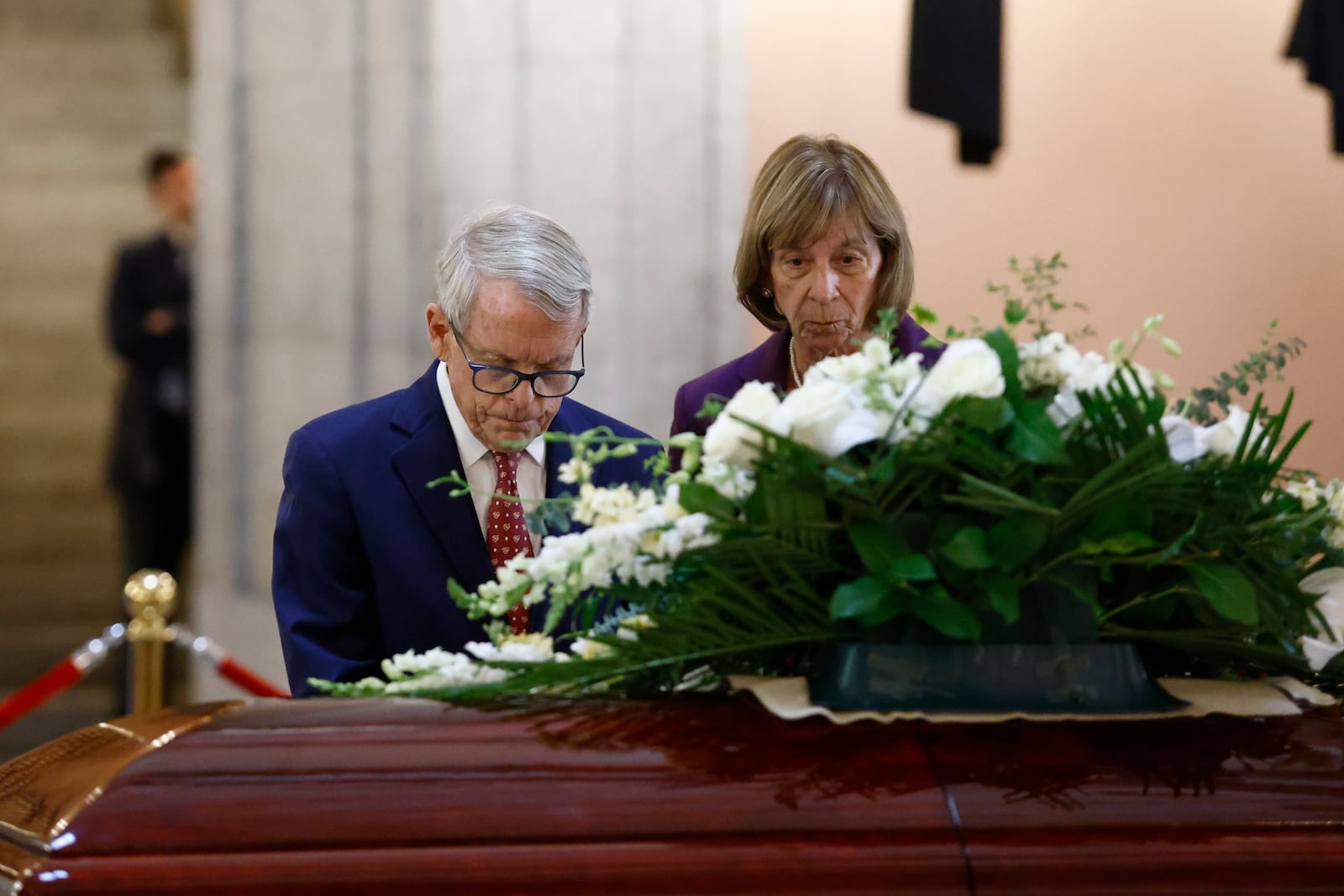 Ohio governor Mike DeWine, left, and his wife Fran pause at the casket for former Ohio House speaker Jo Ann Davidson as it lie in state in the rotunda of the Ohio Sate House in Columbus, Ohio, Thursday, Oct. 31, 2024. (AP Photo/Paul Vernon)