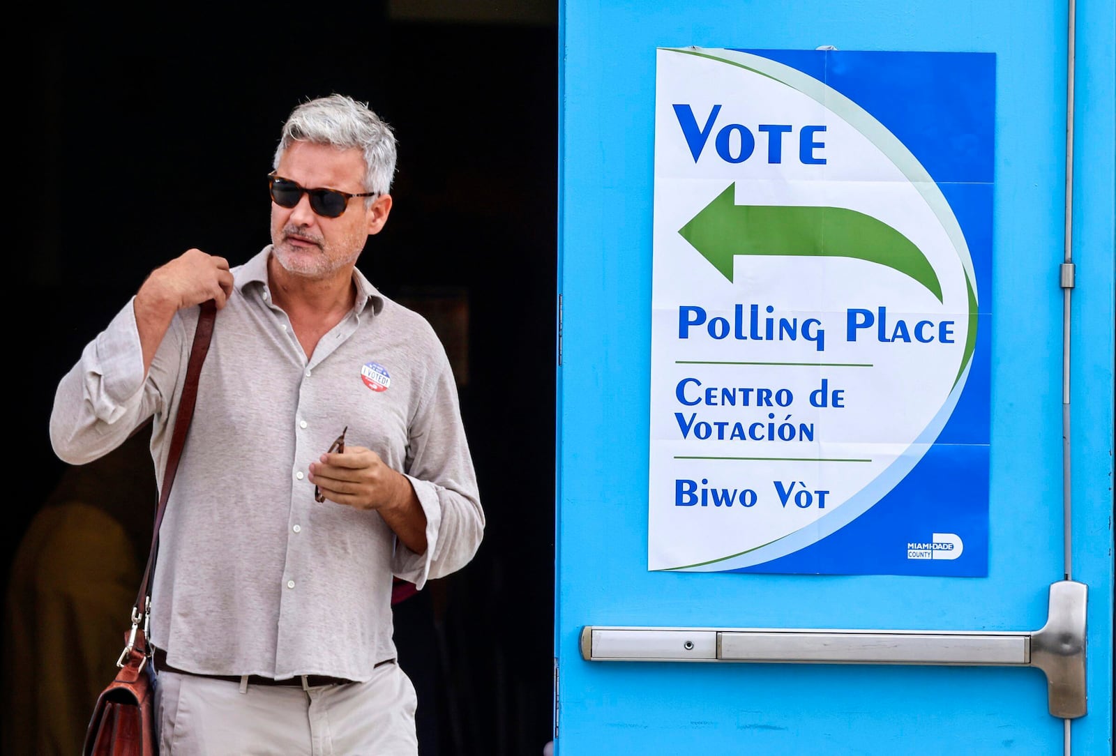 A voter exits the polling station on Election Day at the Little Haiti Cultural Complex's Caribbean Marketplace in Miami's Little Haiti neighborhood on Tuesday, Nov. 5, 2024. (Carl Juste/Miami Herald via AP)