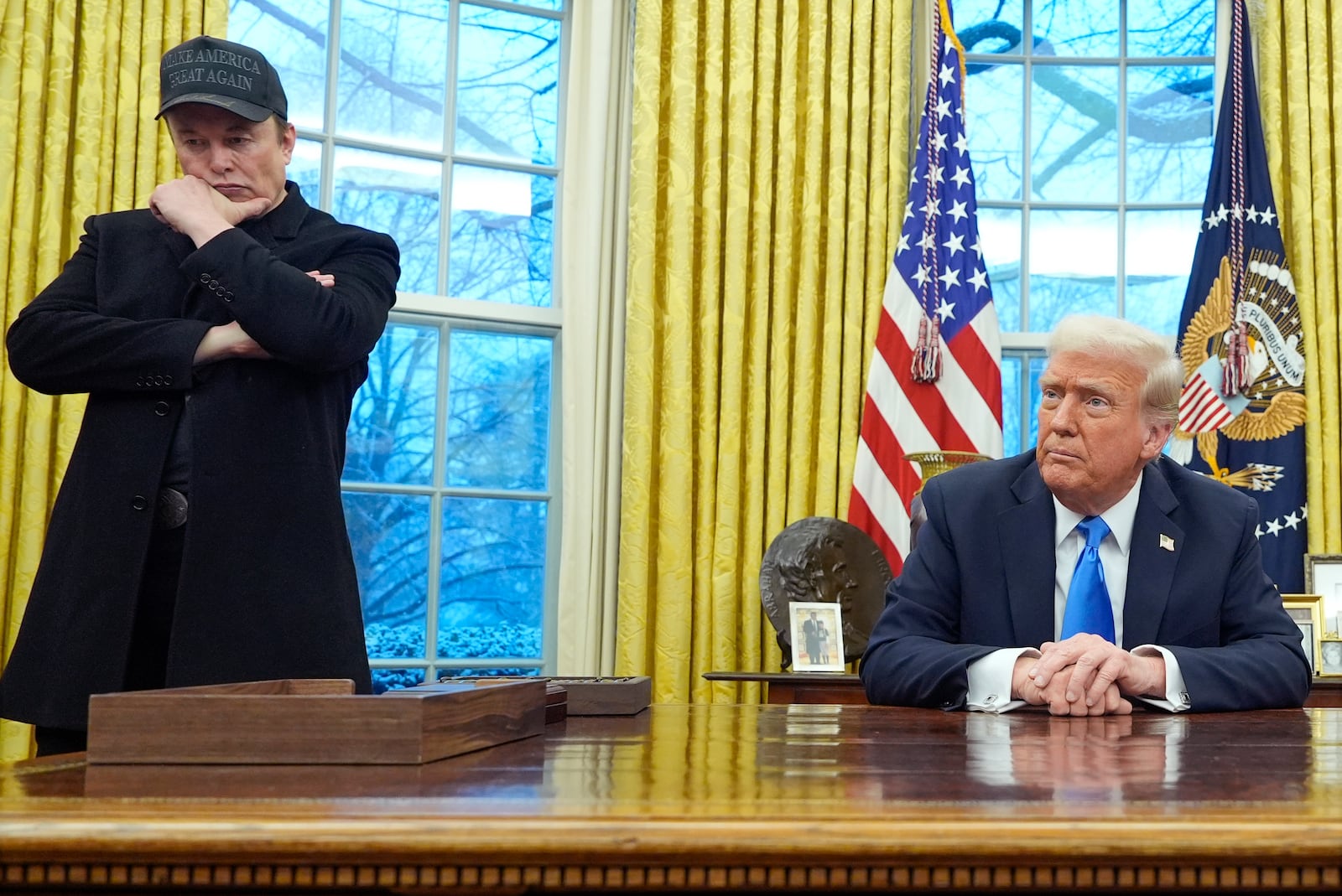 Elon Musk listens as President Donald Trump speaks with reporters in the Oval Office at the White House, Tuesday, Feb. 11, 2025, in Washington. (Photo/Alex Brandon)