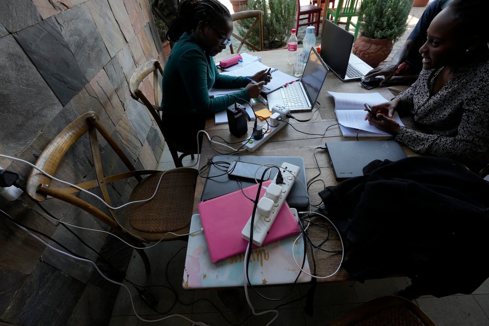 Patrons at a restaurant work on laptops and charge devices at Mercato Cafe in Lusaka, Zambia, Tuesday, Sept. 17, 2024. (AP Photo/Themba Hadebe)