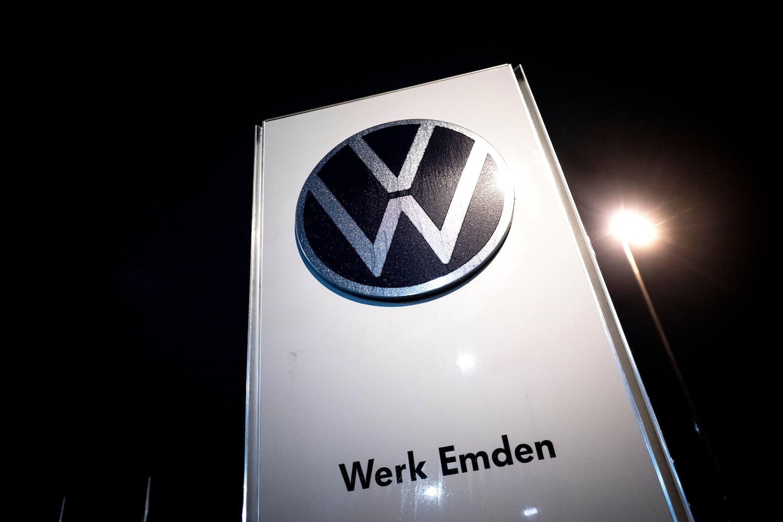 A sign for the Volkswagen plant stands in Emden, Germany, Monday, Dec. 2, 2024. (Sina Schuldt/dpa via AP)