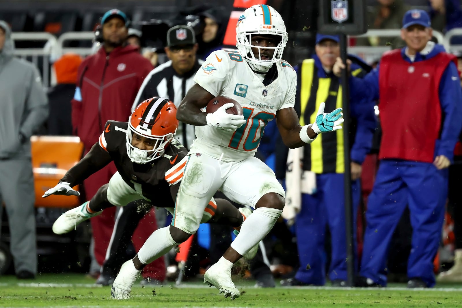 Miami Dolphins wide receiver Tyreek Hill (10) runs past Cleveland Browns safety Juan Thornhill (1) during an NFL football game, Sunday, Dec. 29, 2024, in Cleveland. (AP Photo/Kirk Irwin)