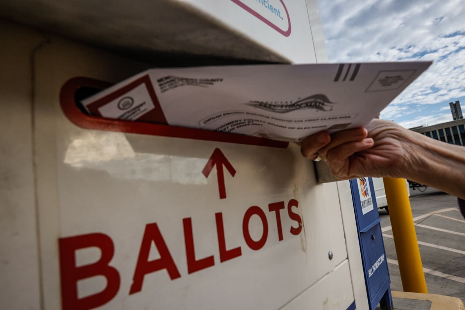 File - A Montgomery County voter drops her ballot off in the dropbox outside the Montgomery County Board of Election in November 2023. Jim Noelker/Staff 