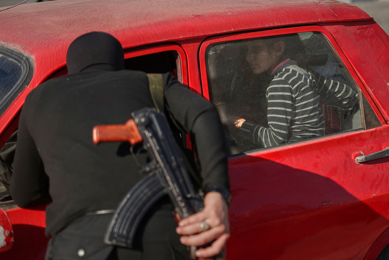 Syrian security forces inspect vehicles at a checkpoint, following a recent wave of violence between Syrian security forces and gunmen loyal to former President Bashar Assad, as well as subsequent sectarian attacks, in Latakia, in Syria's coastal region, Tuesday, March 11, 2025. (AP Photo/Ghaith Alsayed)