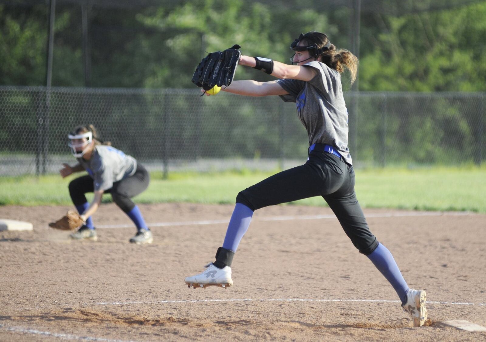 Springboro senior pitcher Molly Pfiffner delivers and sophomore third baseman Celia Blankenship gets set during a 10-1 second-round defeat of visiting Springfield on Wednesday, May 8, 2019. MARC PENDLETON / STAFF