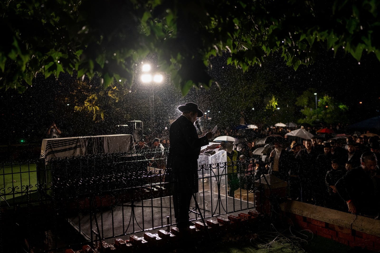 A rabbi gives an eulogy next to the coffin containing the remains of Israeli-Moldovan rabbi Zvi Kogan in Kfar Chabad, Israel, Monday Nov. 25, 2024. Kogan, 28, an ultra-Orthodox rabbi, was killed last week in Dubai where he ran a kosher grocery store. Israelis have flocked for commerce and tourism since the two countries forged diplomatic ties in the 2020 Abraham Accords.(AP Photo/Ohad Zwigenberg)