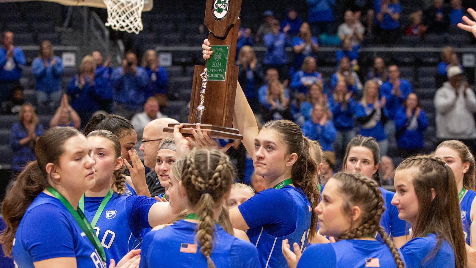 Bryn Martin holds up the runner-up trophy as she and her teammates show it to their fans in appreciation of their support after the Panthers lost to Olmsted Falls in the Division I state final Saturday night at UD Arena. Jeff Gilbert/CONTRIBUTED