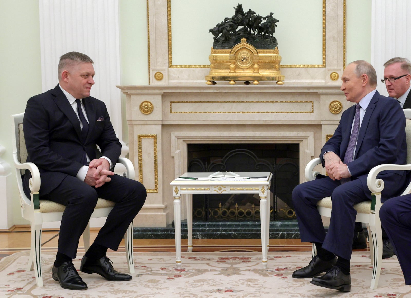 Russian President Vladimir Putin, right, and Slovak Prime Minister Robert Fico talk to each other during their meeting at the Kremlin in Moscow, Russia, Sunday, Dec. 22, 2024. (Gavriil Grigorov, Sputnik, Government Pool Photo via AP)