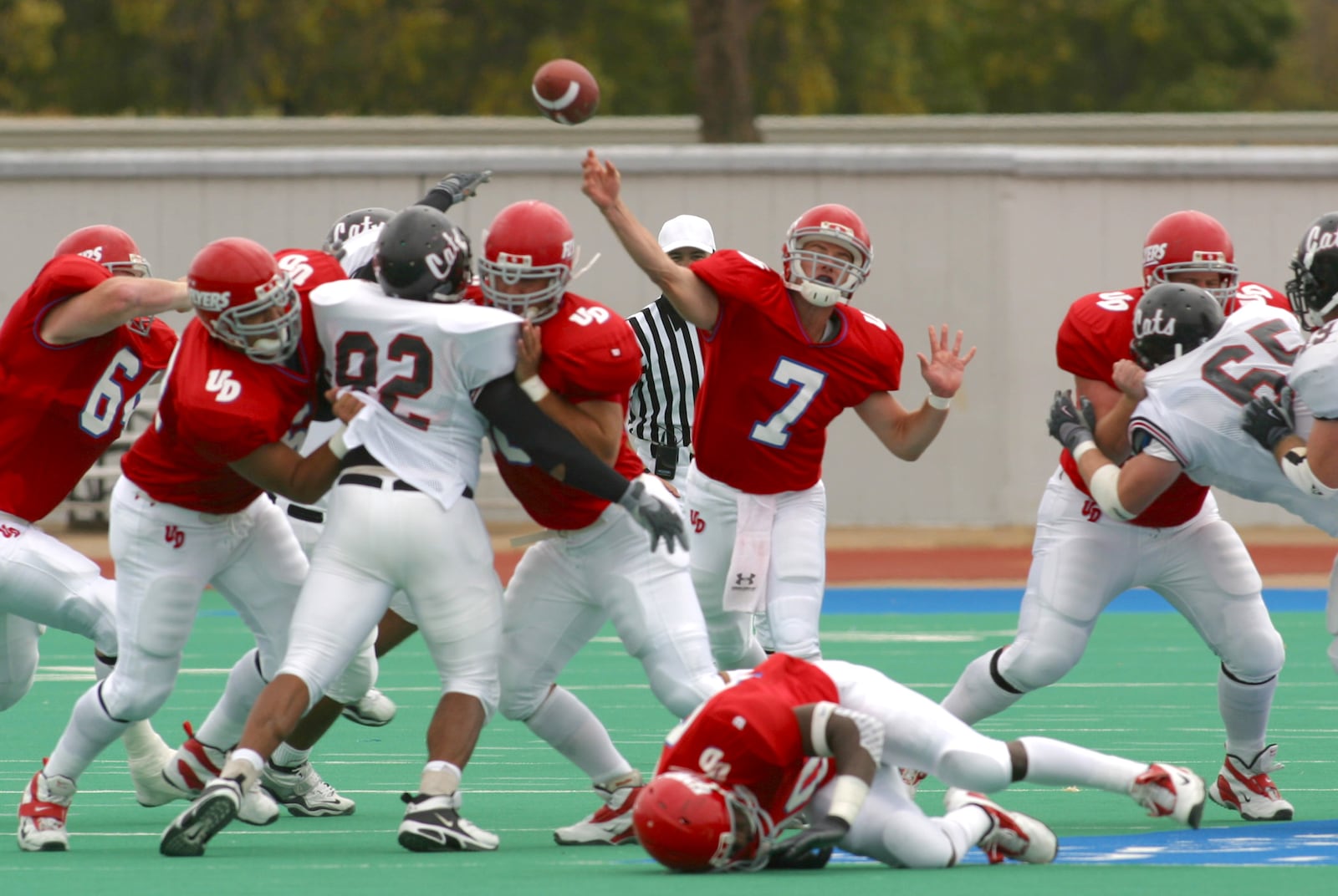 10-2-04 -- University of Dayton's quarterback Brandon Staley passes the ball as the Flyers linemen hold back the Davidson defense during second quarter action at Welcome Stadium. Ty Greenlees/DDN