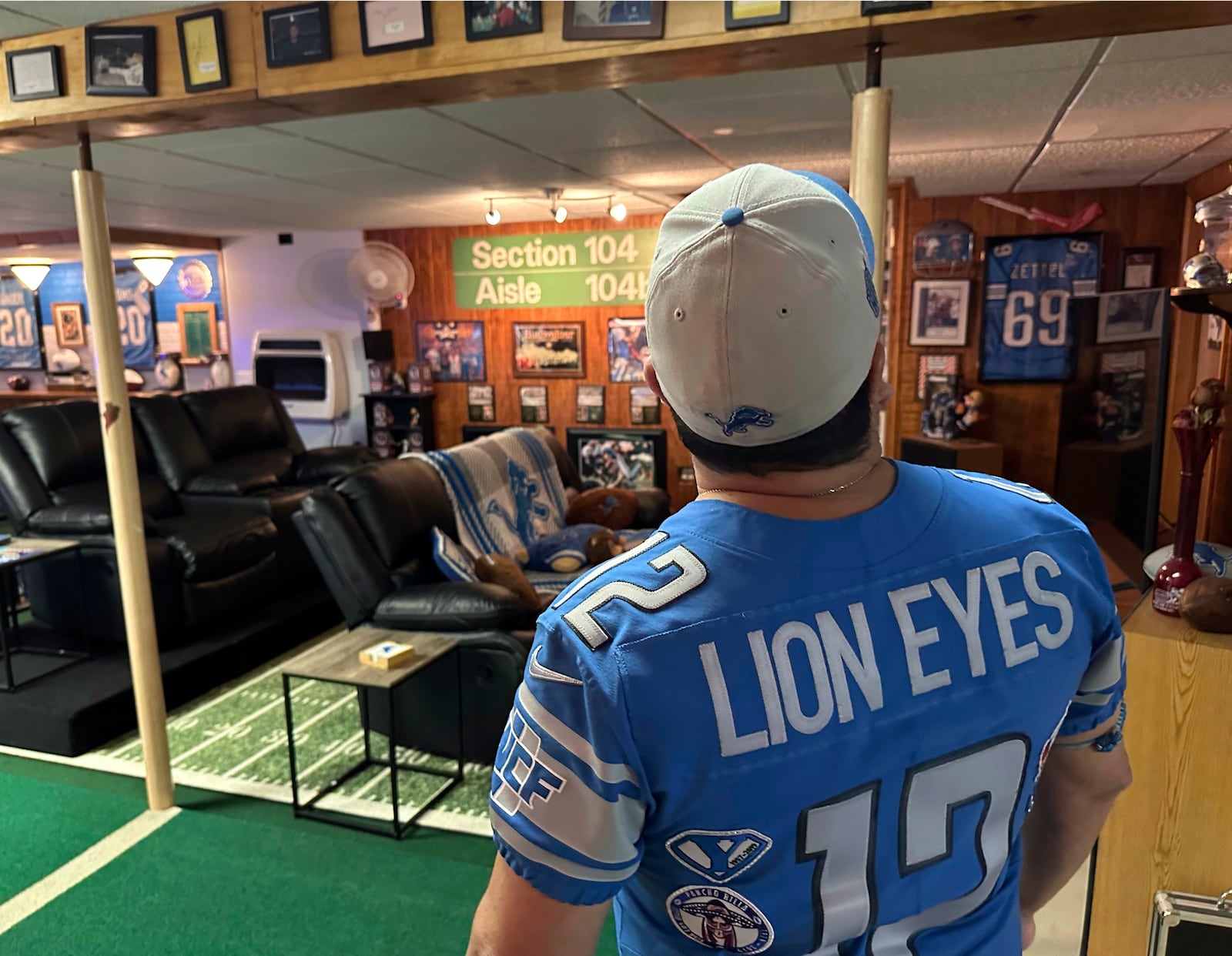 Detroit Lions NFL football fan Rob Gonzales looks up while standing in the basement of his home Thursday, Jan. 16, 2025, in Frenchtown Township, Mich. (AP Photo/Mike Householder)