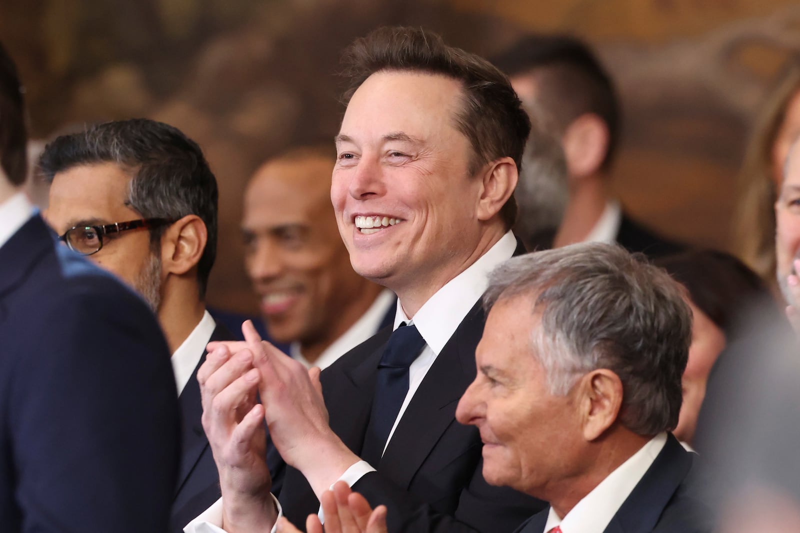 Elon Musk listens as President Donald Trump speaks after taking the oath of office at the 60th Presidential Inauguration in the Rotunda of the U.S. Capitol in Washington, Monday, Jan. 20, 2025. (Kevin Lamarque/Pool Photo via AP)