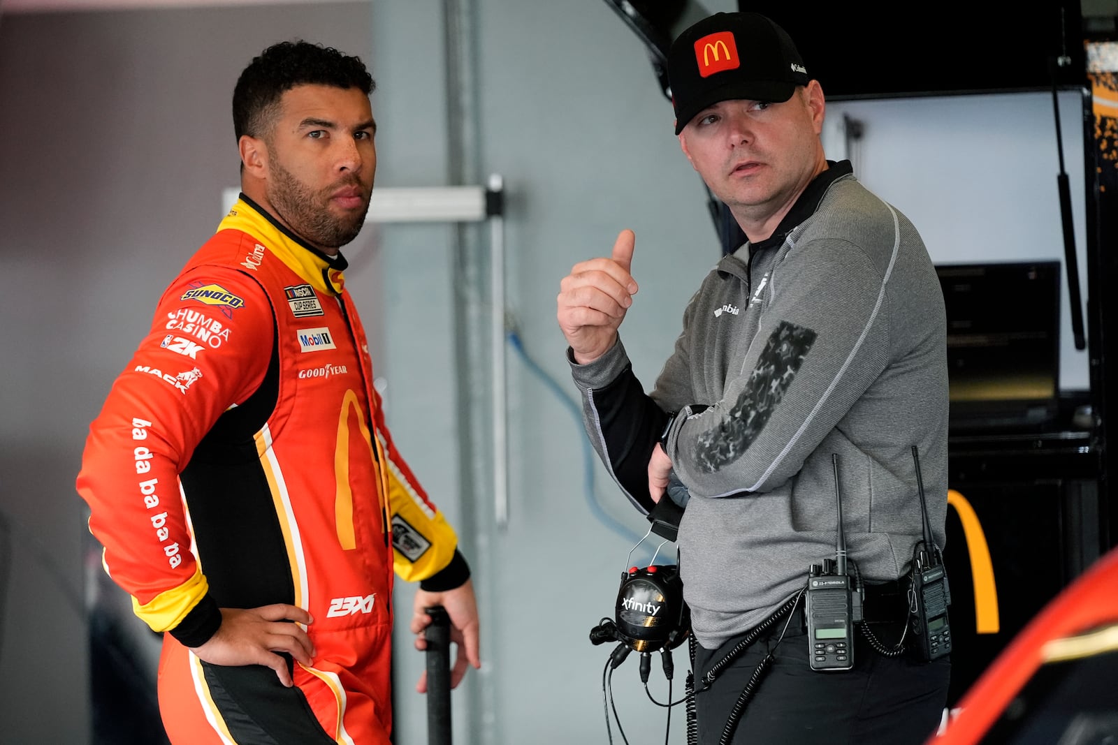 Bubba Wallace, left, talks with his crew chief Charles Denise in the garage during practice for the NASCAR Daytona 500 auto race at Daytona International Speedway, Wednesday, Feb. 12, 2025, in Daytona Beach, Fla. (AP Photo/John Raoux)