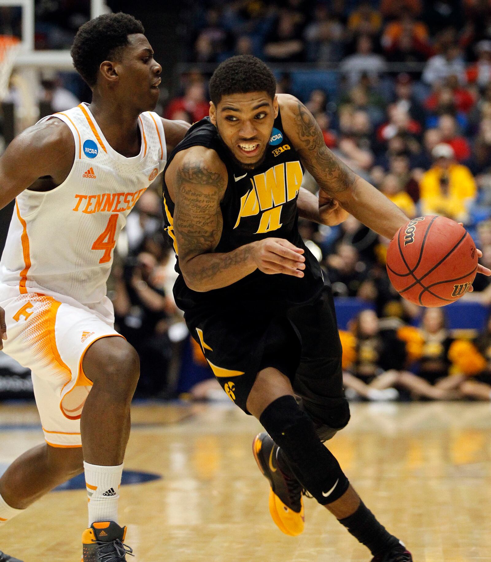 Iowa's Roy Devyn Marble drives past Tennessee's Armani Moore in the First Four games of the NCAA Basketball Championship at University of Dayton Arena. TY GREENLEES / STAFF