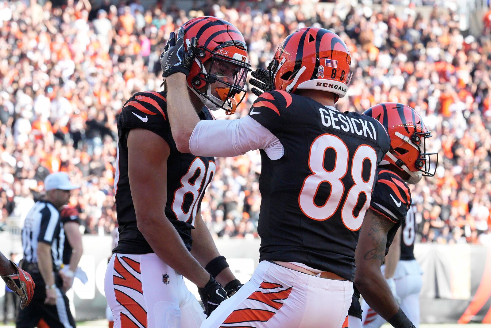 Cincinnati Bengals wide receiver Andrei Iosivas, left, celebrates with tight end Mike Gesicki (88) after scoring a touchdown against the Las Vegas Raiders during the first half of an NFL football game in Cincinnati, Sunday, Nov. 3, 2024. (AP Photo/Jeff Dean)