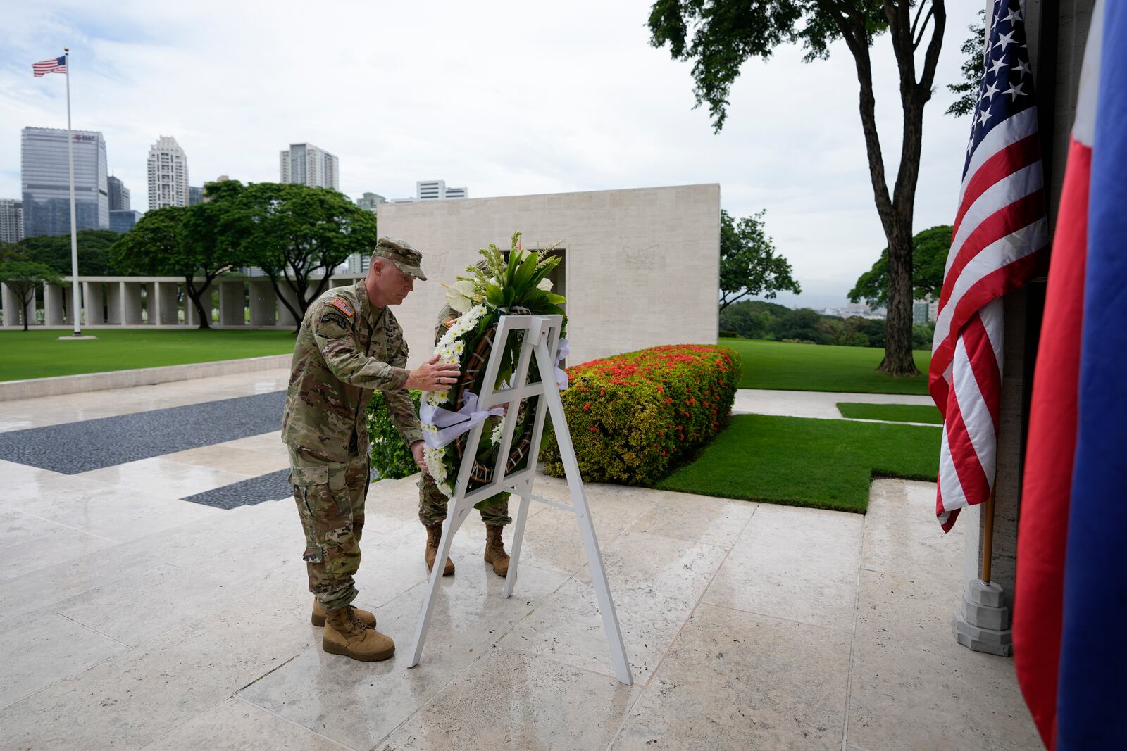 U.S. Maj. Gen. Marcus Evans, left, commanding general of the U.S. Army's 25th Infantry Division and Sgt. Major Shaun Curry arrange a wreath during rites to honor American soldiers died during World War II at the Manila American Cemetery and Memorial in Taguig, Philippines Monday, Oct. 21, 2024. (AP Photo/Aaron Favila)