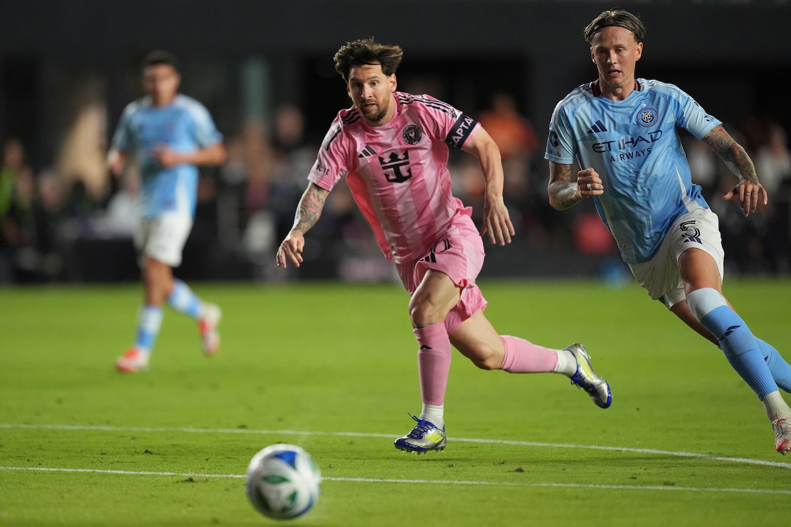 Inter Miami forward Lionel Messi, left, and New York City FC defender Birk Risa (5) vie for the ball during the first half of an MLS soccer match, Saturday, Feb. 22, 2025, in Fort Lauderdale, Fla. (AP Photo/Rebecca Blackwell)