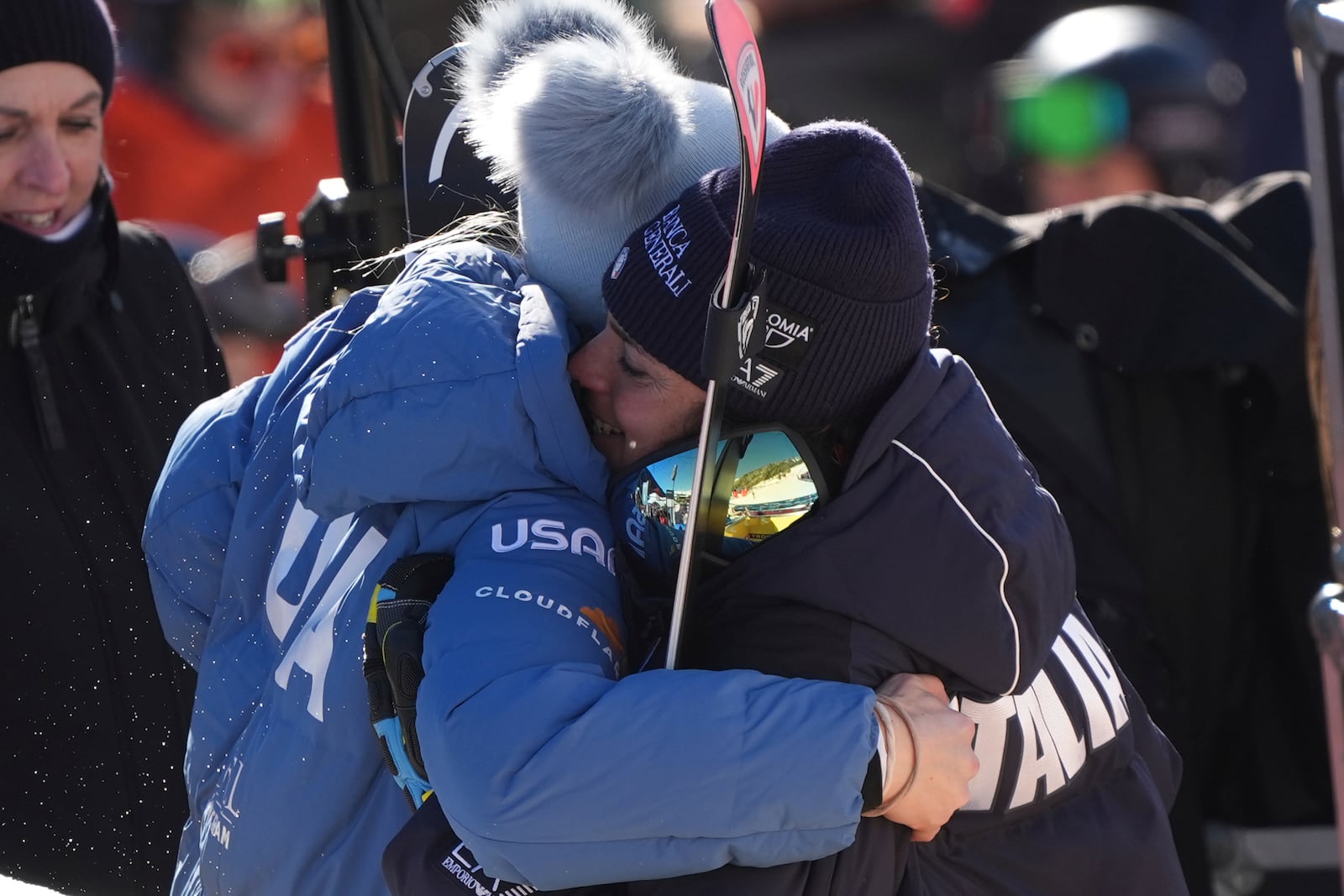 United States Lindsey Vonn embraces Italy's Federica Brignone after completing an alpine ski, women's World Cup downhill race, in St. Anton, Austria, Saturday, Jan. 11, 2025. (AP Photo/Giovanni Auletta)