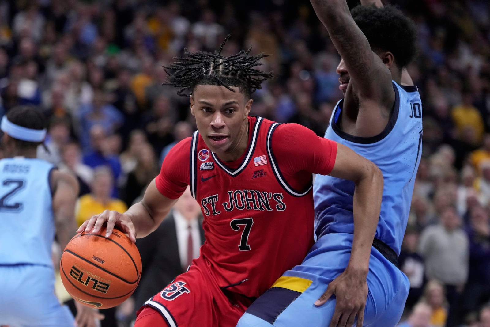 St. John's's Simeon Wilcher tries to get around Marquette's Kam Jones during the second half of an NCAA college basketball game Saturday, March 8, 2025, in Milwaukee. (AP Photo/Morry Gash)