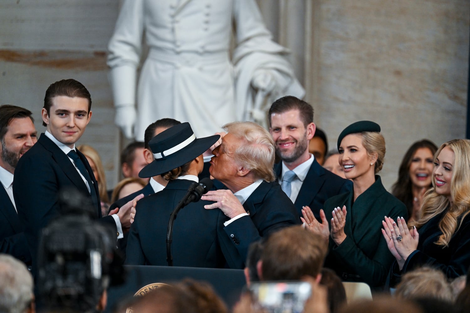 
                        President Donald Trump kisses first lady Melania Trump after he was sworn in by Supreme Court Chief Justice John Roberts during his inauguration ceremony as the 47th president in the Rotunda at the Capitol in Washington on Monday morning, Jan. 20, 2025. (Kenny Holston/The New York Times)
                      