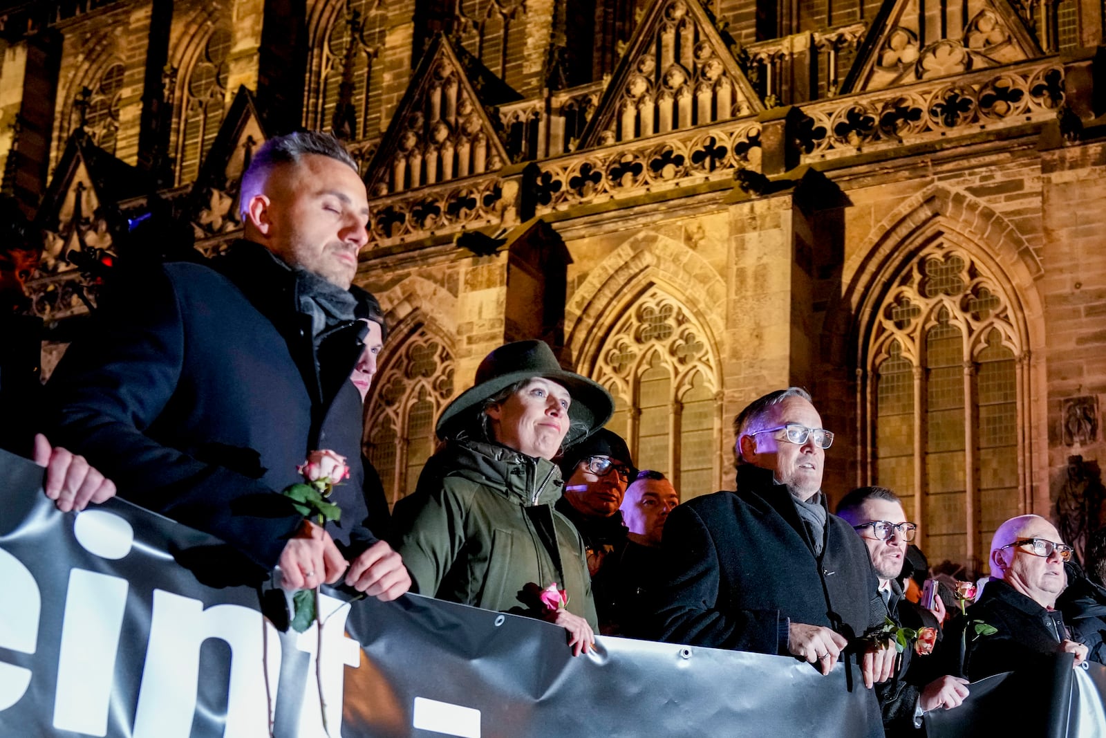 Co leader of German far right party AfD Alice Weidel,center, attends an AfD election campaign in front of the cathedral in Magdeburg, Germany, Monday, Dec. 23, 2024. (AP Photo/Ebrahim Noroozi)