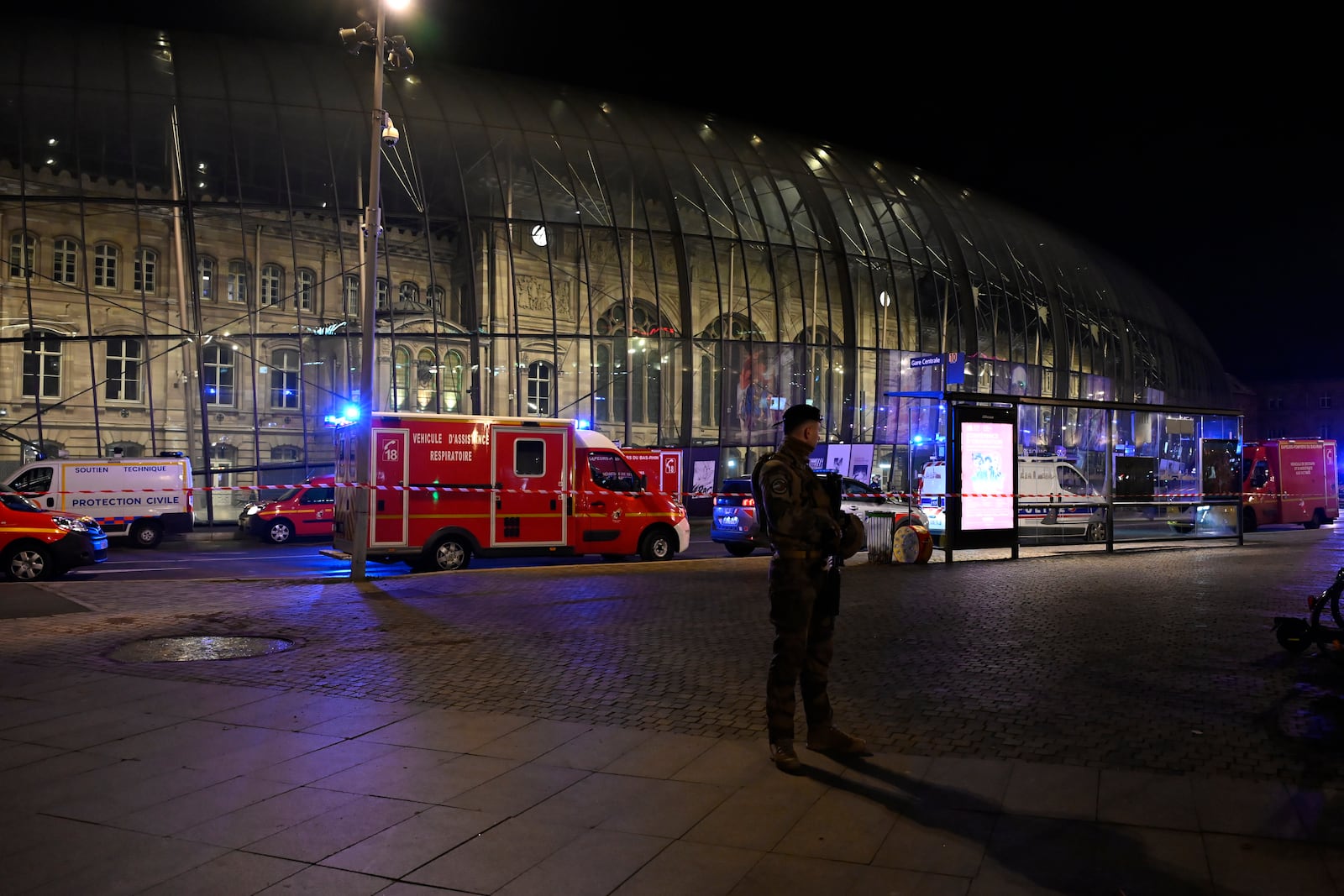 A soldier guards the train station after two trams collided, injuring dozens of people, though none critically, firefighters said, Saturday, Jan. 11, 2025 in Strasbourg, eastern France. (AP Photo/Pascal Bastien)