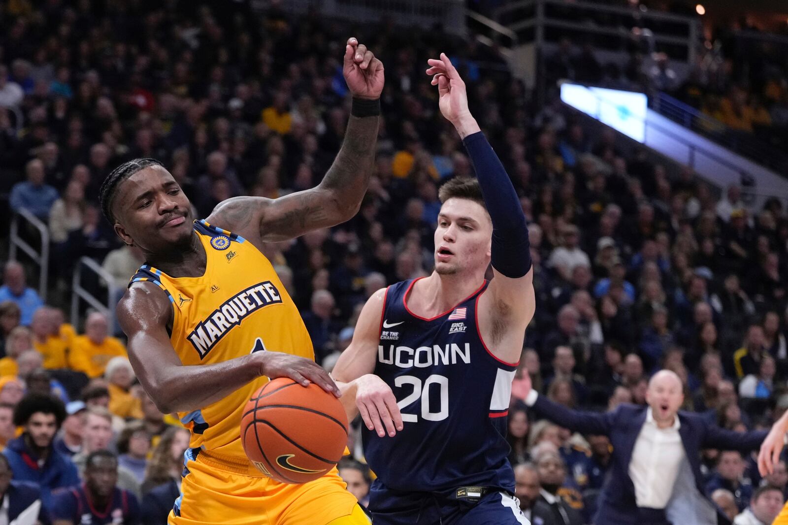 Marquette's Kam Jones is fouled by UConn's Aidan Mahaney during the first half of an NCAA college basketball game Saturday, Feb. 1, 2025, in Milwaukee. (AP Photo/Morry Gash)