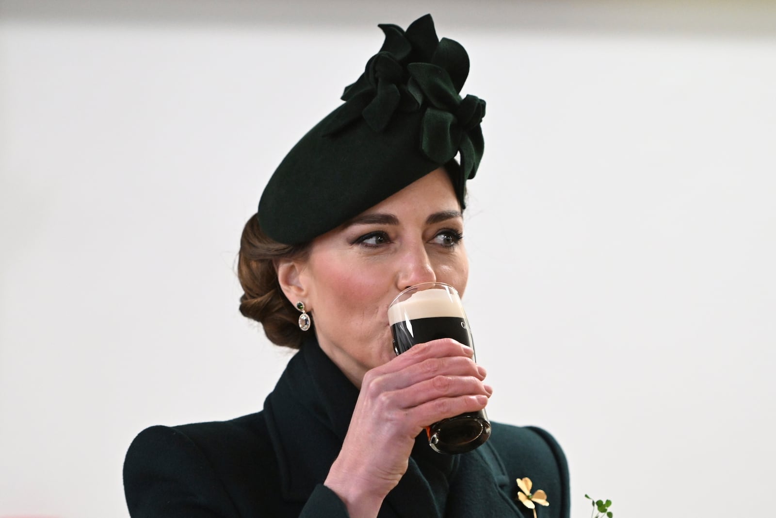 Britain's Kate, the Princess of Wales, drinks Guinness during a reception with the Irish Guards, at a special St Patrick's Day parade and celebration at Wellington Barracks in London, Monday, March 17, 2025. (Eddie Mulholland/Pool Photo via AP)