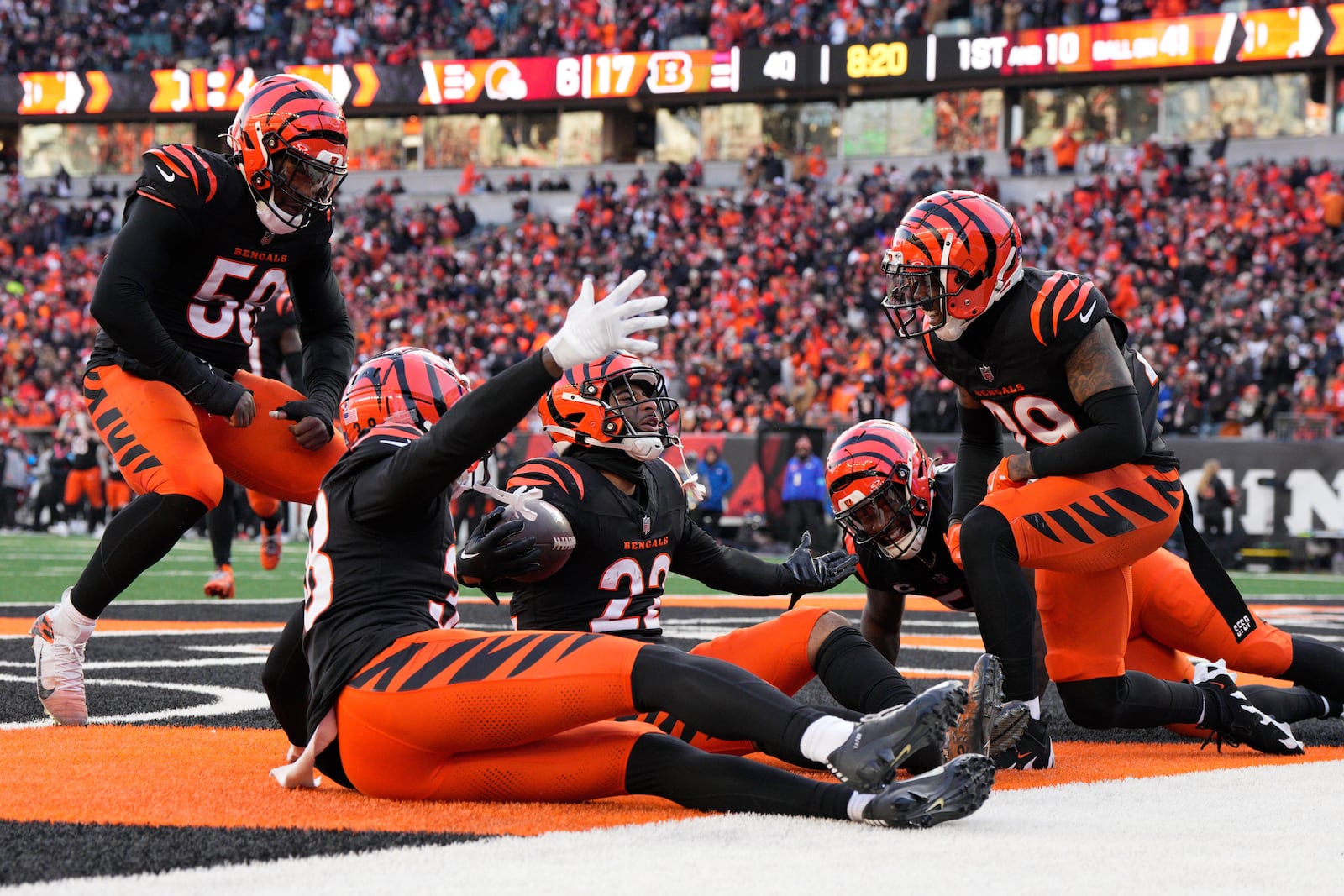 Cincinnati Bengals safety Geno Stone (22) celebrates with teammates after an interception during the second half of an NFL football game against the Cleveland Browns, Sunday, Dec. 22, 2024, in Cincinnati. (AP Photo/Jeff Dean)