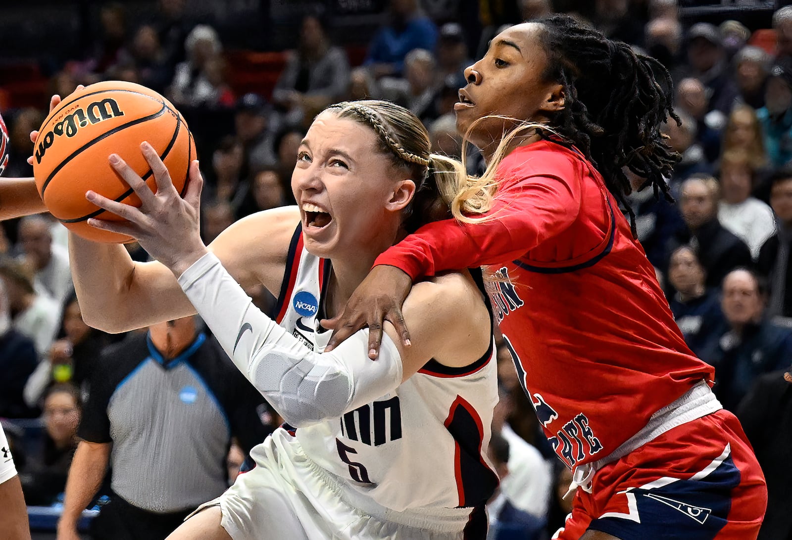 FILE - UConn guard Paige Bueckers, left, is fouled by Jackson State guard Miya Crump in the first half of a first-round college basketball game in the NCAA Tournament, Saturday, March 23, 2024, in Storrs, Conn. (AP Photo/Jessica Hill, File)