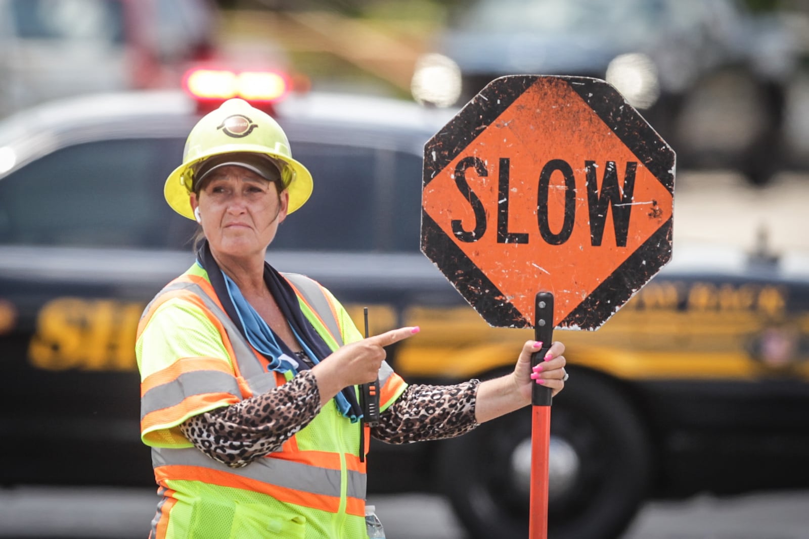 Traffic controller, Toni Massey directs traffic at the busy intersection of Dorothy Lane and Far Hills Avenue. Jim Noelker/Staff