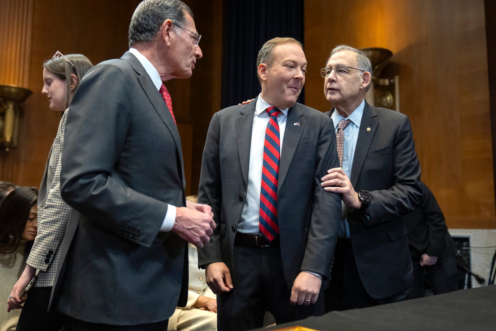 Former Rep. Lee Zeldin, R-N.Y., center, President-elect Donald Trump's pick to head the Environmental Protection Agency, speaks with Sen. John Barrasso, R-Wyo., left, and Sen. John Boozman, R-Ark., before a hearing of the Senate Environment and Public Works Committee on Capitol Hill, Thursday, Jan. 16, 2025, in Washington. (AP Photo/Mark Schiefelbein)