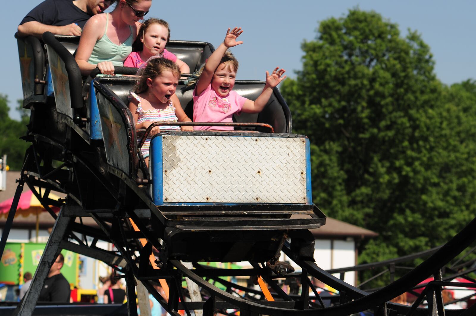 Noelle Dente, left, sits next to Brenna Lowery on a roller coaster at the Hamilton Township Berry Festival in 2012. Hamilton Twp. is the safest locality in the region, according to a trade group study.