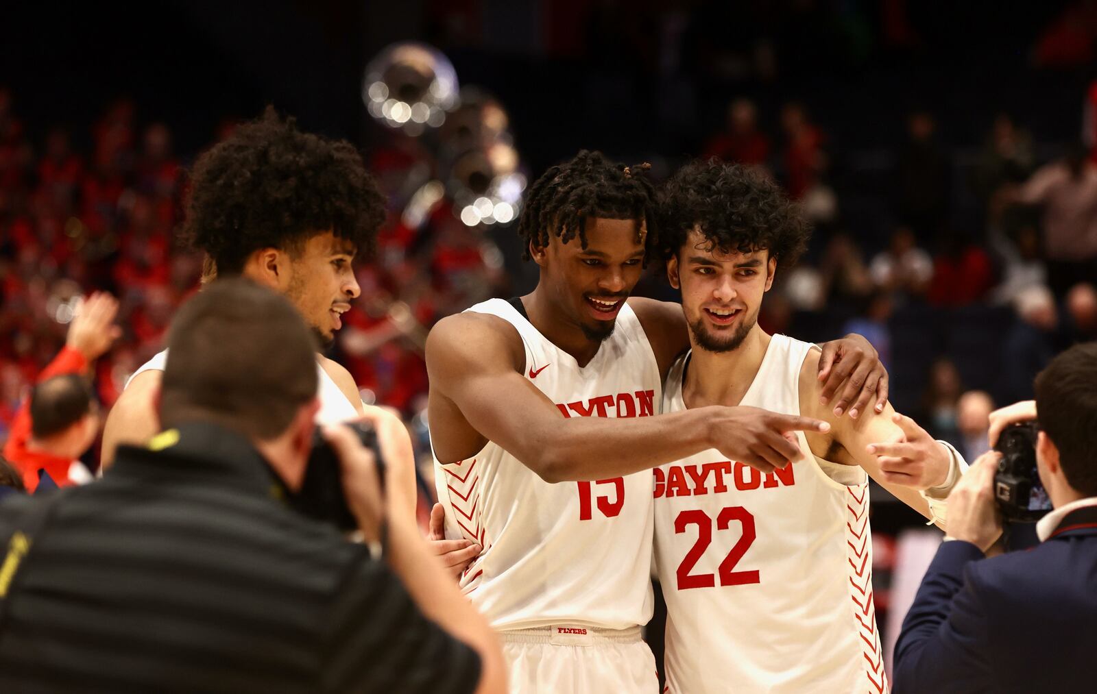 Dayton's Toumani Camara, DaRon Holmes II and Mustapha Amzil pose for the cameras as they leave the court after a victory against Western Michigan on Wednesday, Nov. 30, 2022, at UD Arena. David Jablonski/Staff